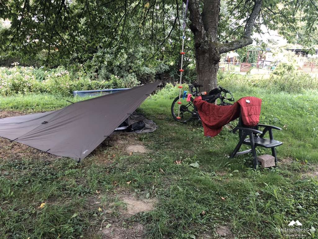 Lager unter dem Tarp am Morgen neben einem kleinen Bach